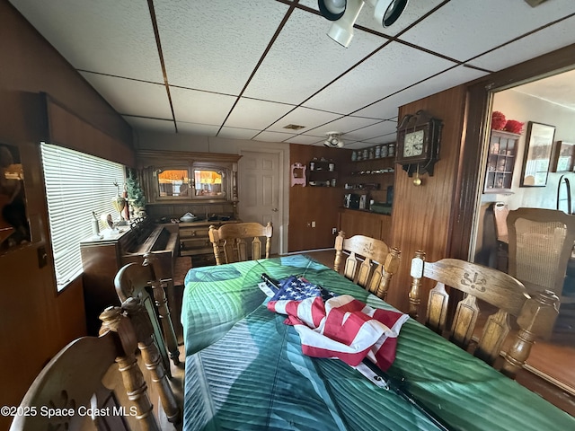 1003 Greenwood Way, Cocoa, FL 32922 - dining space with a paneled ceiling, wood walls, and a ceiling fan
