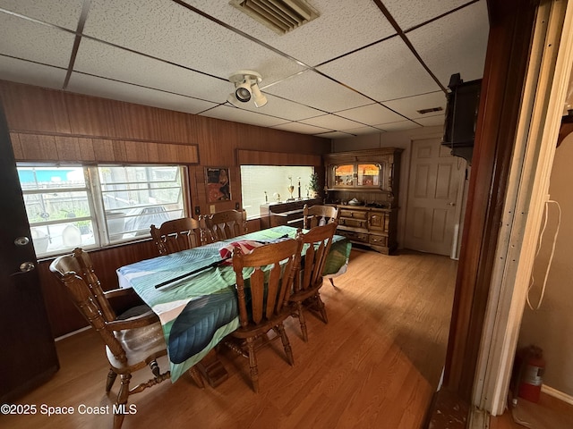 1003 Greenwood Way, Cocoa, FL 32922 - dining space with a drop ceiling, light wood finished floors, healthy amount of natural light, and wooden walls