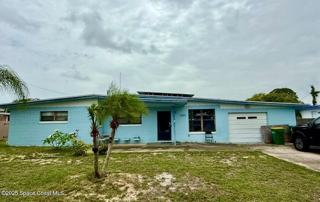 1003 Greenwood Way, Cocoa, FL 32922 - single story home with concrete block siding, a garage, a front yard, and concrete driveway