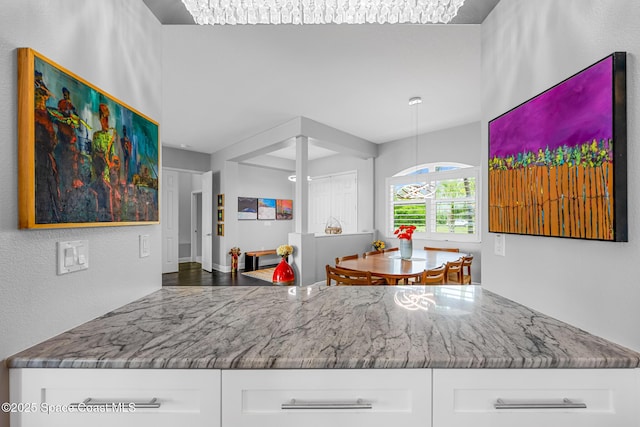 11 Pisces Ln, Rockledge, FL 32955 - kitchen featuring stone counters and white cabinetry
