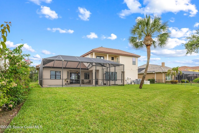 11 Pisces Ln, Rockledge, FL 32955 - rear view of house featuring a ceiling fan, a yard, stucco siding, a lanai, and a patio area
