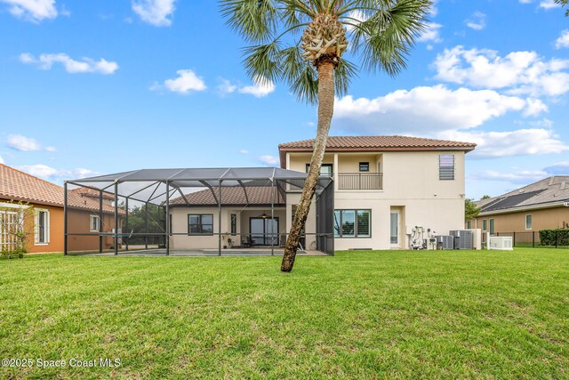 11 Pisces Ln, Rockledge, FL 32955 - rear view of house featuring stucco siding, a tile roof, a yard, a lanai, and a patio area