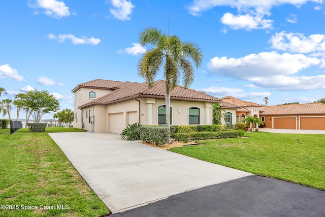 11 Pisces Ln, Rockledge, FL 32955 - mediterranean / spanish house with an attached garage, driveway, stucco siding, a tiled roof, and a front lawn