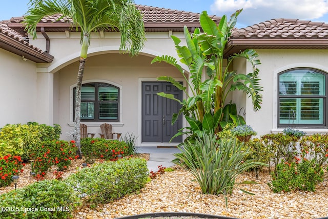 11 Pisces Ln, Rockledge, FL 32955 - entrance to property with a tiled roof and stucco siding