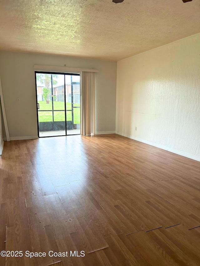 1704 University Ln Unit 703, Cocoa, FL 32922 - unfurnished room featuring wood finished floors, baseboards, and a textured ceiling