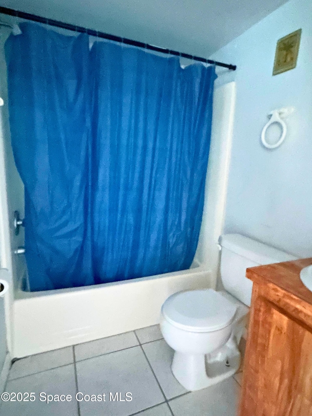 1704 University Ln Unit 703, Cocoa, FL 32922 - bathroom featuring shower / bath combination with curtain, toilet, tile patterned flooring, and vanity