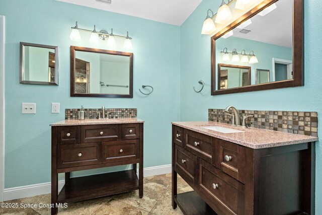 816 Pine Shadows Ave W, Rockledge, FL 32955 - bathroom featuring two vanities and backsplash