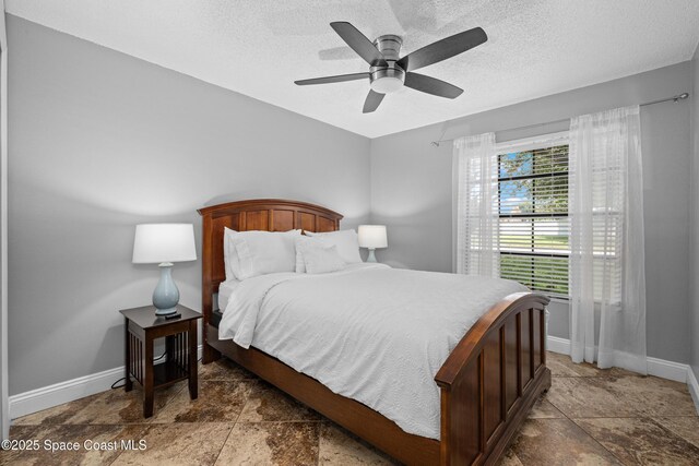 816 Pine Shadows Ave W, Rockledge, FL 32955 - bedroom with stone finish floors, a textured ceiling, and ceiling fan