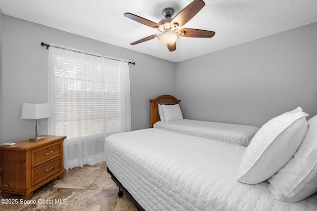 816 Pine Shadows Ave W, Rockledge, FL 32955 - bedroom with a textured ceiling and ceiling fan