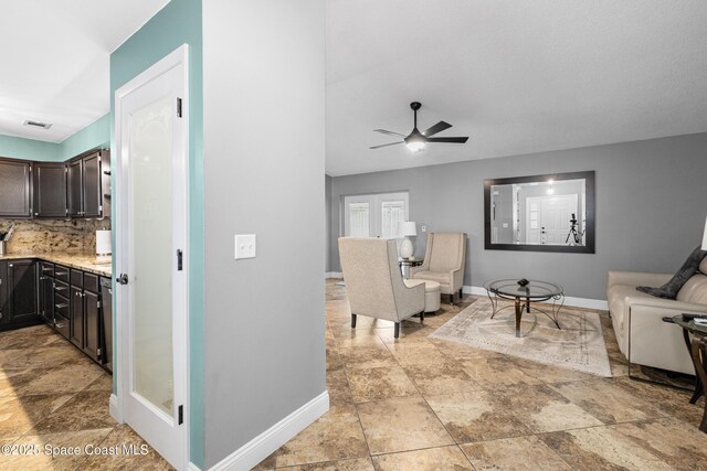 816 Pine Shadows Ave W, Rockledge, FL 32955 - living room featuring a ceiling fan and light stone finish floors