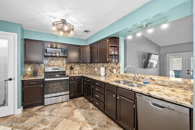 816 Pine Shadows Ave W, Rockledge, FL 32955 - kitchen with appliances with stainless steel finishes, open shelves, tasteful backsplash, dark brown cabinets, and light stone counters
