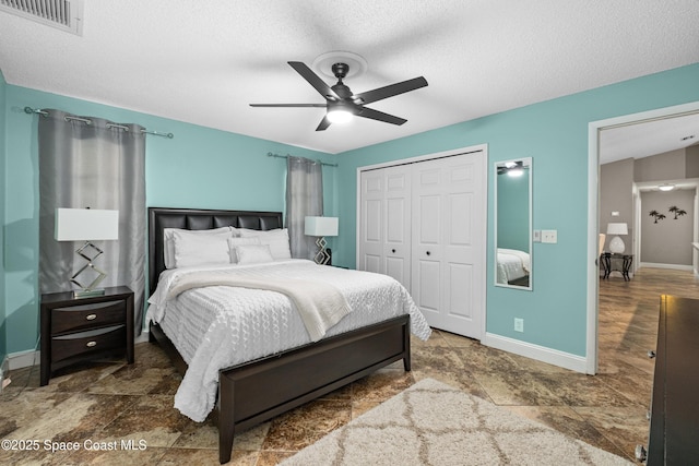 816 Pine Shadows Ave W, Rockledge, FL 32955 - bedroom with a closet, a textured ceiling, and a ceiling fan
