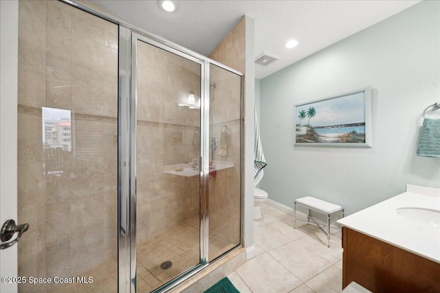 601 N Miramar Ave Unit 314, Indialantic, FL 32903 - full bathroom with toilet, vanity, a stall shower, tile patterned flooring, and recessed lighting