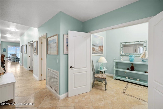 601 N Miramar Ave Unit 314, Indialantic, FL 32903 - corridor featuring tile patterned floors and baseboards