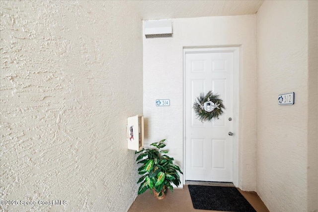 601 N Miramar Ave Unit 314, Indialantic, FL 32903 - doorway to property with stucco siding