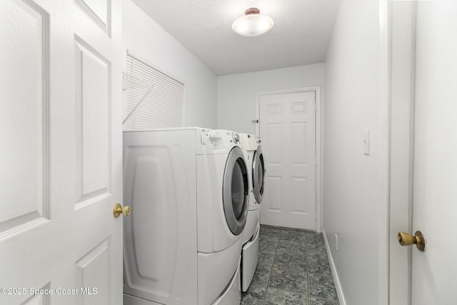 7413 Ester Rd, Cocoa, FL 32927 - laundry room featuring washer and clothes dryer and a textured ceiling