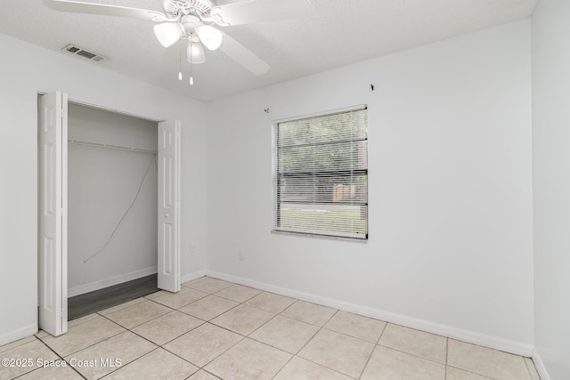 7413 Ester Rd, Cocoa, FL 32927 - unfurnished bedroom featuring light tile patterned floors, a closet, and a ceiling fan