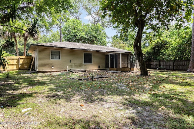 7413 Ester Rd, Cocoa, FL 32927 - back of property with a fenced backyard and a sunroom
