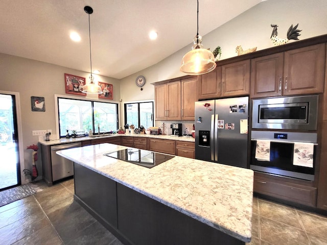 451 Mallard Ln, Indialantic, FL 32903 - kitchen with appliances with stainless steel finishes, lofted ceiling, light stone countertops, a sink, and a center island
