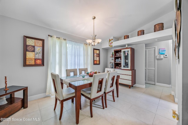 402 Ainsley St SE, Palm Bay, FL 32909 - dining area featuring a chandelier, baseboards, and light tile patterned flooring