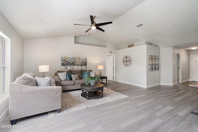 542 White Plains Ave SW, Palm Bay, FL 32908 - living area featuring ceiling fan, wood finished floors, a textured ceiling, baseboards, and vaulted ceiling