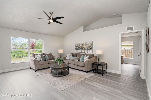 542 White Plains Ave SW, Palm Bay, FL 32908 - living room featuring a ceiling fan, wood finished floors, baseboards, a textured ceiling, and lofted ceiling