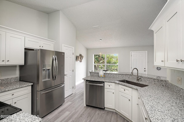 542 White Plains Ave SW, Palm Bay, FL 32908 - kitchen with stainless steel appliances, a sink, a textured ceiling, white cabinets, and light wood-style floors