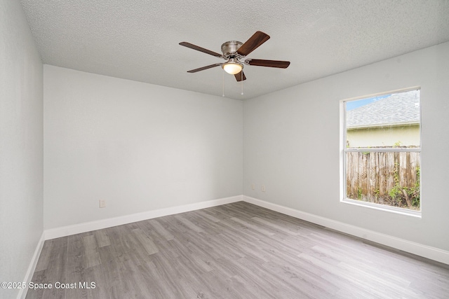 542 White Plains Ave SW, Palm Bay, FL 32908 - unfurnished room with wood finished floors, plenty of natural light, ceiling fan, a textured ceiling, and baseboards