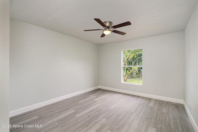 542 White Plains Ave SW, Palm Bay, FL 32908 - unfurnished room with wood finished floors, baseboards, ceiling fan, and a textured ceiling