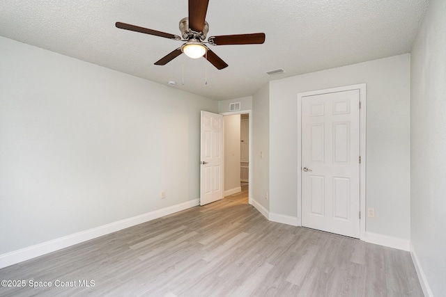 542 White Plains Ave SW, Palm Bay, FL 32908 - unfurnished bedroom with light wood-type flooring, baseboards, ceiling fan, and a textured ceiling