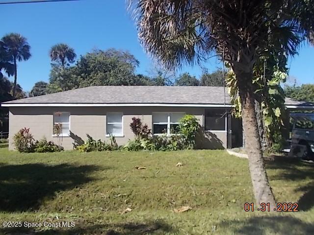 209 Plumosa Dr, Cocoa, FL 32922 - ranch-style home with a front yard