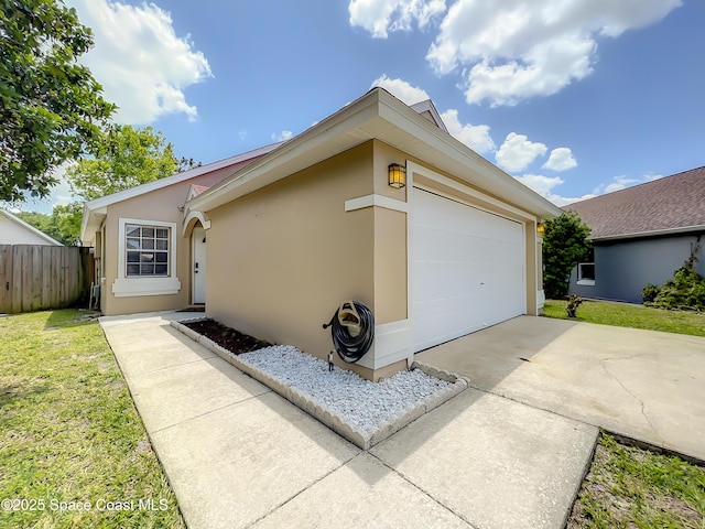 10360 Crystal Point Dr, Orlando, FL 32825 - view of front of house with stucco siding, a garage, and driveway