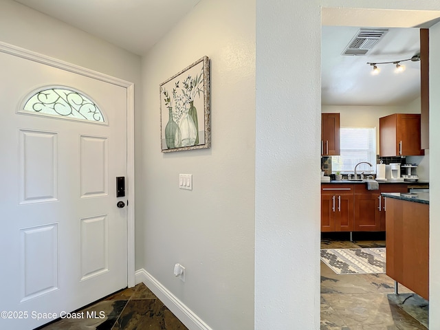 10360 Crystal Point Dr, Orlando, FL 32825 - entrance foyer featuring baseboards and dark stone finish flooring