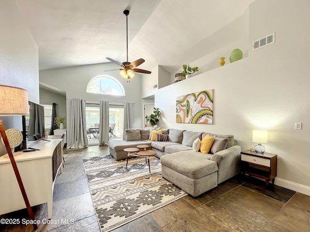 10360 Crystal Point Dr, Orlando, FL 32825 - living room featuring ceiling fan, stone tile floors, high vaulted ceiling, and baseboards
