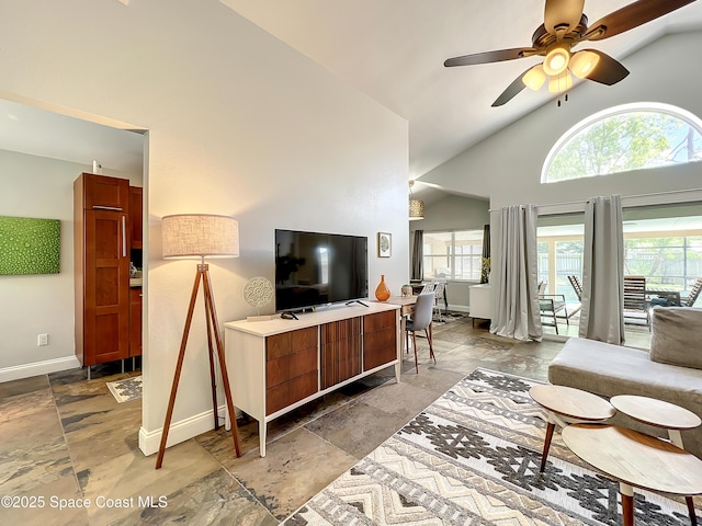 10360 Crystal Point Dr, Orlando, FL 32825 - living area featuring stone tile flooring, baseboards, healthy amount of natural light, a ceiling fan, and high vaulted ceiling