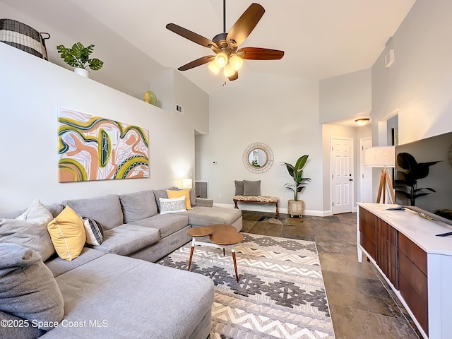 10360 Crystal Point Dr, Orlando, FL 32825 - living area with high vaulted ceiling, ceiling fan, baseboards, and dark stone finish flooring