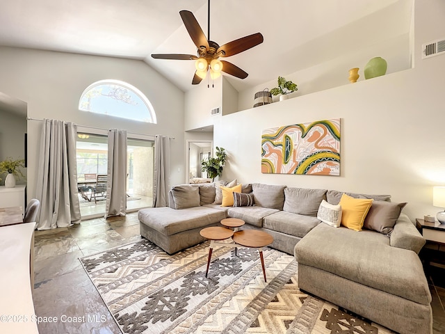 10360 Crystal Point Dr, Orlando, FL 32825 - living room featuring a ceiling fan, high vaulted ceiling, and stone tile floors