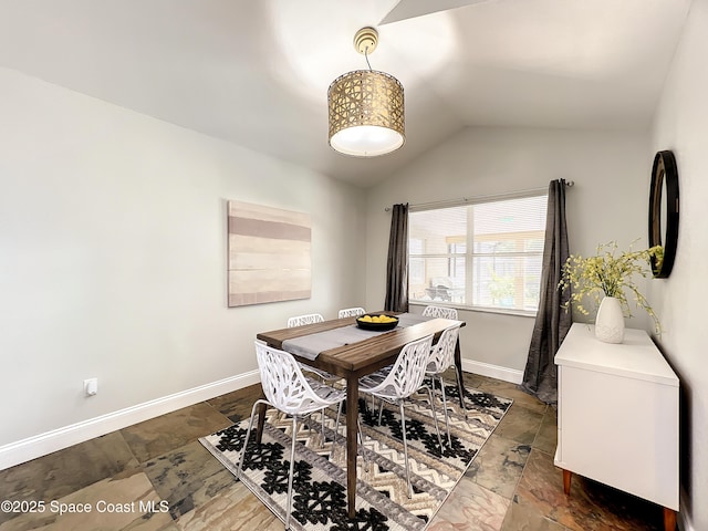 10360 Crystal Point Dr, Orlando, FL 32825 - dining room with stone tile flooring, lofted ceiling, and baseboards