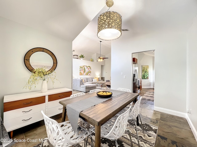 10360 Crystal Point Dr, Orlando, FL 32825 - dining room with stone tile floors, a ceiling fan, high vaulted ceiling, and baseboards