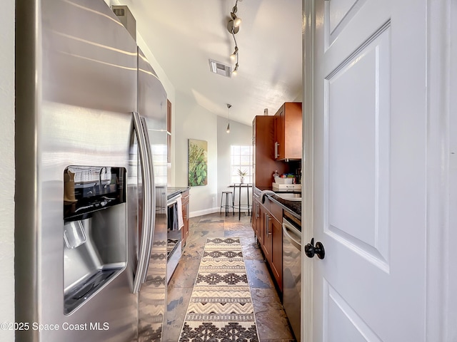 10360 Crystal Point Dr, Orlando, FL 32825 - kitchen featuring stainless steel appliances, brown cabinets, dark countertops, and lofted ceiling