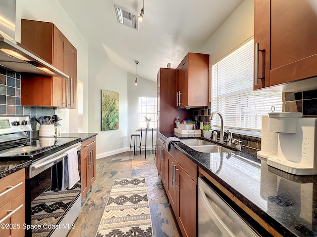 10360 Crystal Point Dr, Orlando, FL 32825 - kitchen with stainless steel appliances, a sink, wall chimney range hood, lofted ceiling, and tasteful backsplash