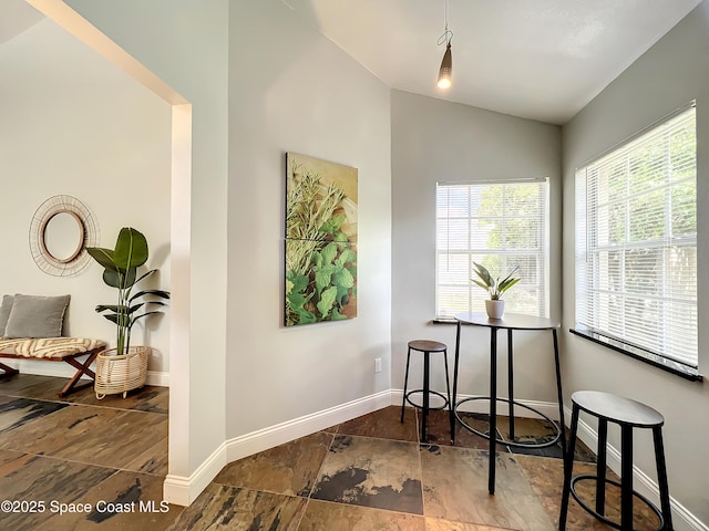 10360 Crystal Point Dr, Orlando, FL 32825 - office area featuring baseboards, vaulted ceiling, and stone finish floors