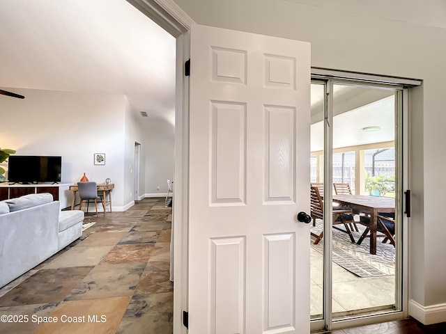 10360 Crystal Point Dr, Orlando, FL 32825 - entryway with baseboards and stone finish flooring