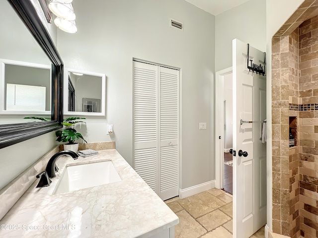 10360 Crystal Point Dr, Orlando, FL 32825 - bathroom with a closet, vanity, tiled shower, and baseboards