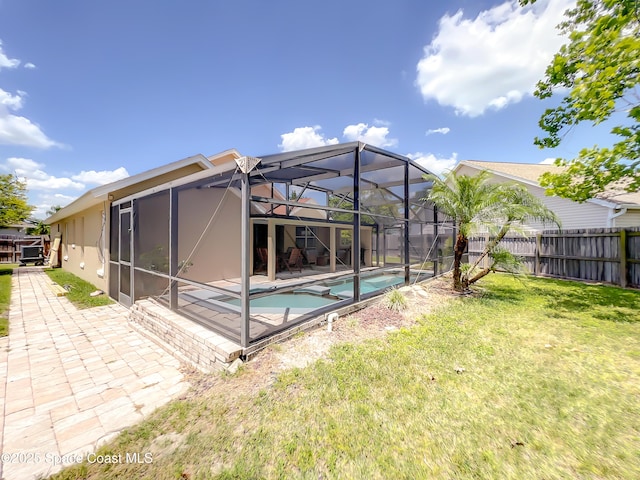 10360 Crystal Point Dr, Orlando, FL 32825 - back of house featuring a patio area, stucco siding, an in-ground hot tub, and glass enclosure
