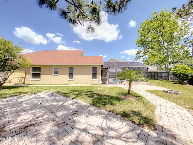 10360 Crystal Point Dr, Orlando, FL 32825 - back of house with stucco siding, a patio area, and glass enclosure