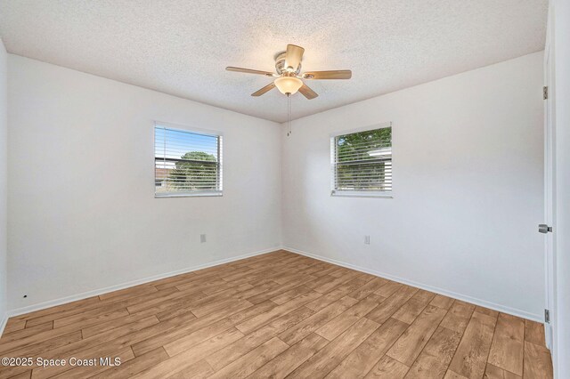 1123 Hermosa Dr, Rockledge, FL 32955 - empty room featuring light wood-style flooring, a textured ceiling, a ceiling fan, and baseboards
