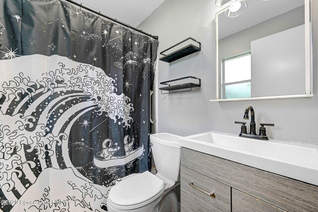 1123 Hermosa Dr, Rockledge, FL 32955 - full bath featuring toilet, vanity, and a shower with shower curtain