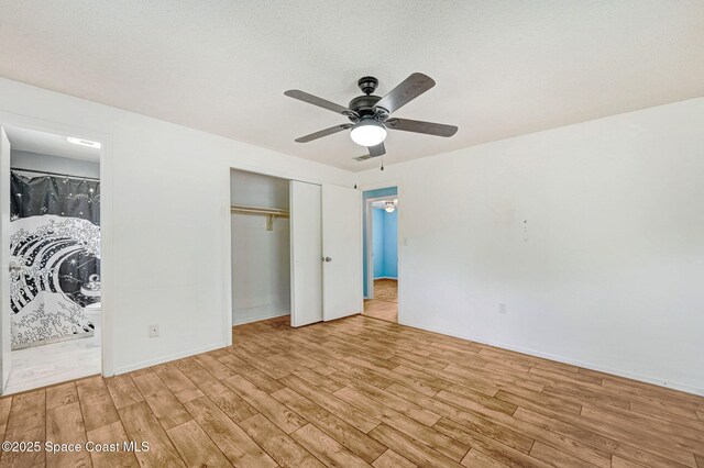 1123 Hermosa Dr, Rockledge, FL 32955 - unfurnished bedroom featuring light wood-style floors, a closet, connected bathroom, and ceiling fan