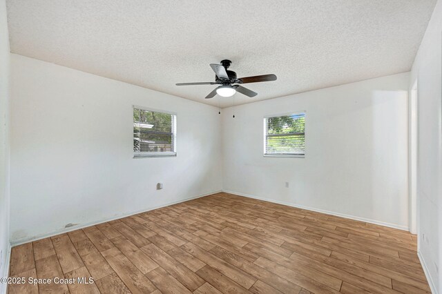 1123 Hermosa Dr, Rockledge, FL 32955 - spare room featuring light wood finished floors, plenty of natural light, a textured ceiling, and ceiling fan